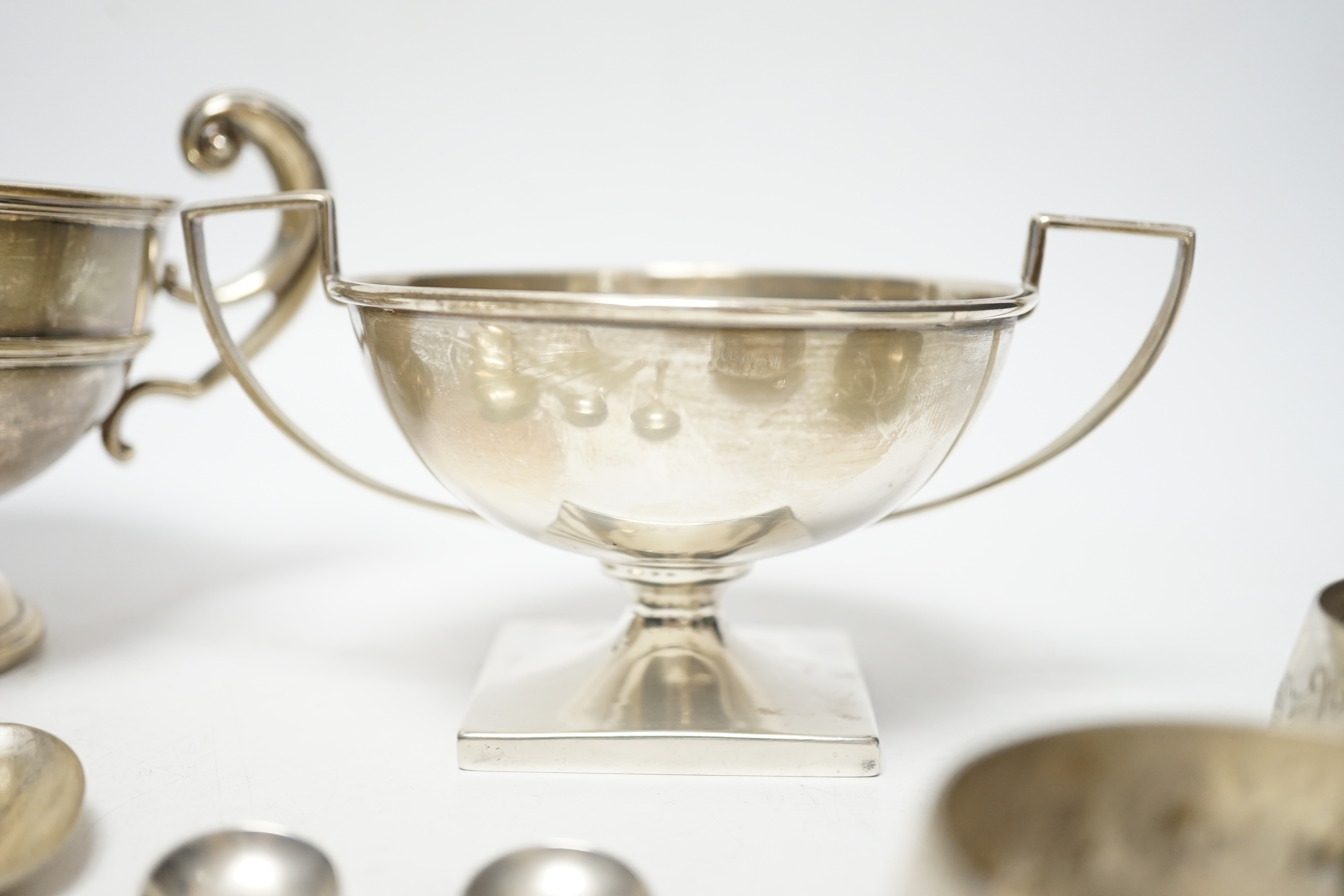 An Edwardian silver two handled bowl, Chester, 1902, diameter 10.4cm, a sterling bowl, a pair of engraved silver tub salts and matching salt spoons, Mappin & Webb, Sheffield, 1908 and a set of five silver teaspoons.